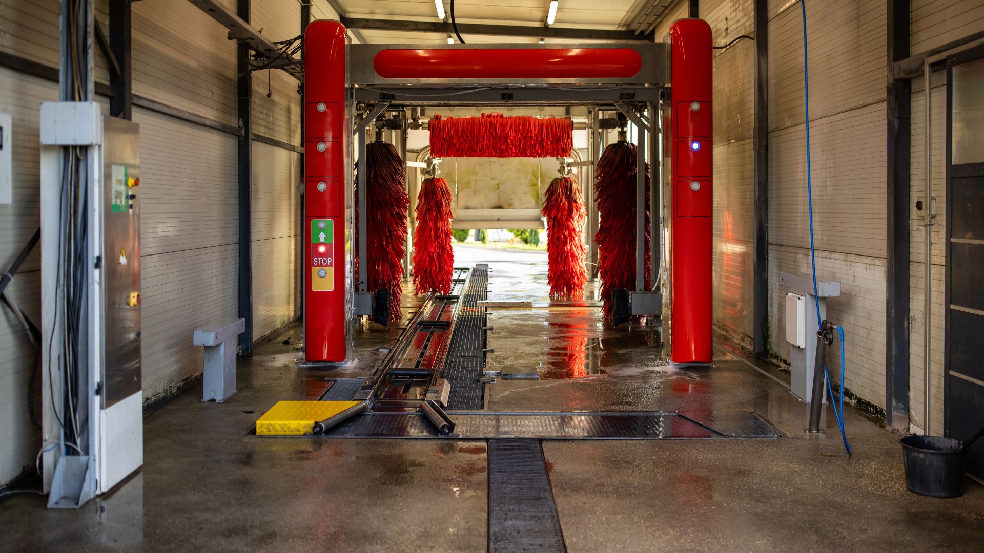 Red automatic car wash with brushes ready to clean a vehicle